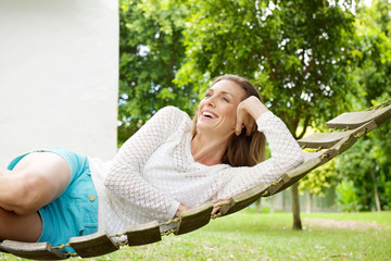 Fototapeta premium Beautiful woman smiling on hammock outdoors