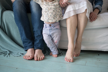 Fototapeta na wymiar Cute newborn foot with family members