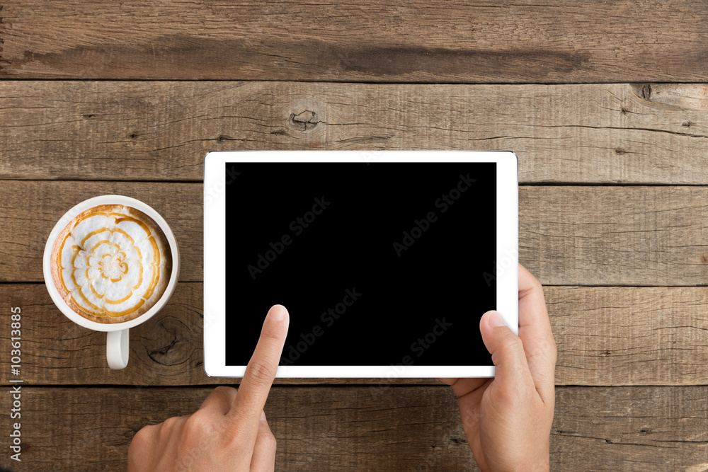 Wall mural hand using mockup tablet on wood desk with clipping path display easy add element