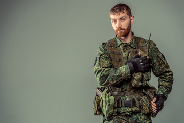 Special forces soldier with rifle on dark background
