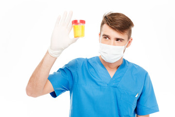 Fototapeta na wymiar Male doctor holding bottle of urine sample