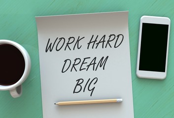 Work Hard Dream Big, message on paper, smart phone and coffee on table