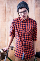 Serious hipster holding a bike