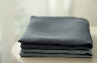 grey towels pile isolated on wooden background