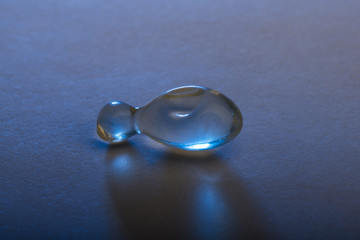 Gel capsule illuminated with blue lighting