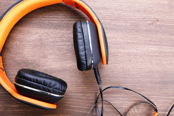 Headphones on wooden background