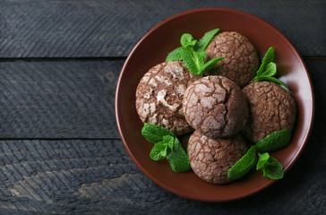 Chocolate chip cookie with mint on plate, closeup