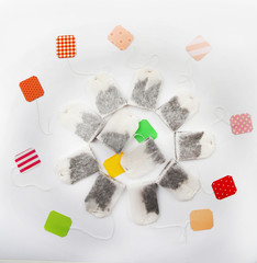 Unused teabags with colourful labels isolated on white background