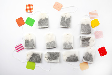 Unused teabags with colourful labels isolated on white background