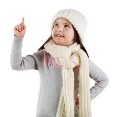 Little girl in a trendy knitted clothes looking up, isolated on white