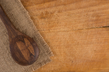 Serving spoons on burlap cloth on wooden surface image brown ton