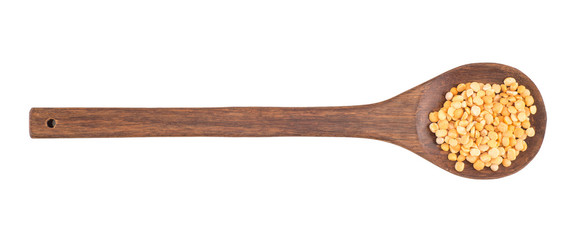 Dried peas in a wooden spoon on a white background