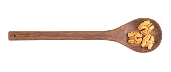 Walnuts on a wooden spoon isolated white background