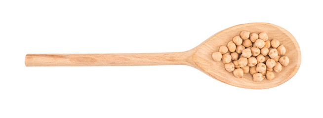 uncooked chickpeas in wooden spoon on white background
