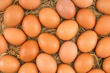 Chicken eggs lying on hay. Symbol of life and Easter.