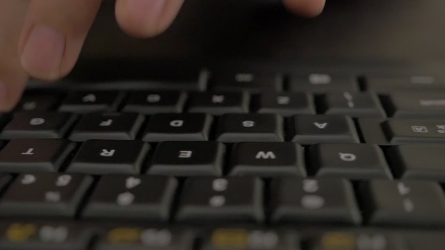 Woman typing on black keyboard in slow motion while dolly with camera passing by 1080p FullHD footage - Female fingers typing on keyboard in slow-mo 1920X1080 HD video 