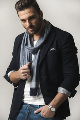 Handsome man in shirt,jacket,scarf,jeans