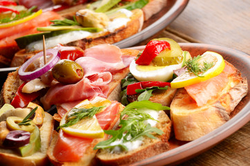 Open sandwiches with salmon, eggs, mussels, jamon and herring