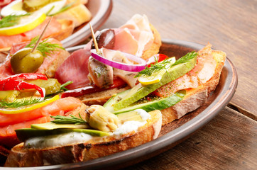 Open sandwiches with salmon, eggs, mussels, jamon and herring