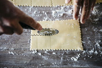 Step by step handmade ravioli on a wooden table. Series