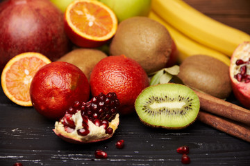 Close view at kiwi with tropical fruits on background