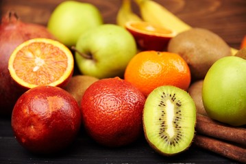 Close view at kiwi with tropical fruits on background