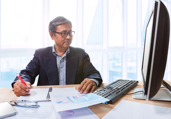 senior business man working on office tabel with computer and bu