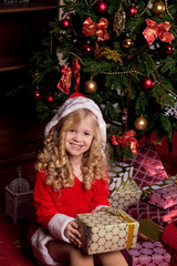 Happy small girl in dress with present have a christmas