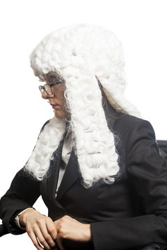 Female judge wearing a wig with eyeglasses isolated on white