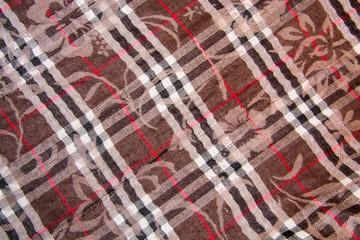 brown woolen fabric with flowers and black-and-white stripes