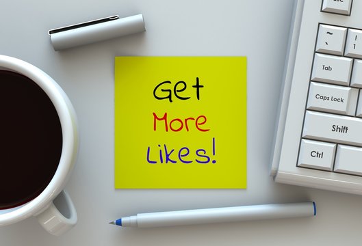 Get More Likes, message on note paper, computer and coffee on table