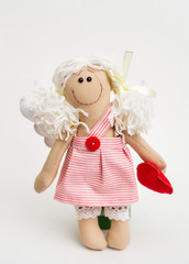 Doll angel with his hands on white background