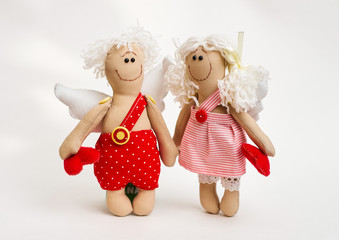 Doll angel with his hands on white background