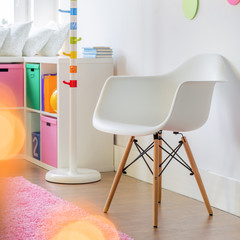 White chair and color accessories in child's room
