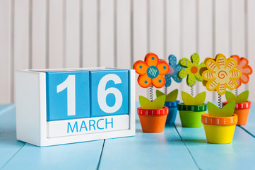 March 16th. Image of march 16 wooden color calendar with flower on white background.  Spring day
