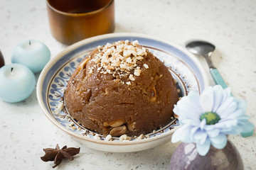 
semolina halva, halvah, halava sweet desert with raisiins and nuts