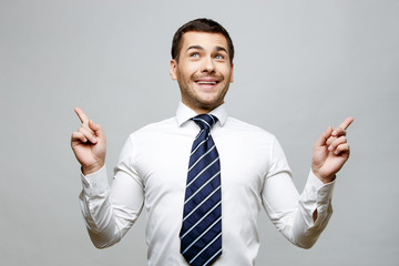 Handsome stylish businessman on grey background