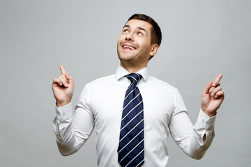 Handsome stylish businessman on grey background