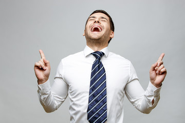 Handsome stylish businessman on grey background