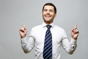 Handsome stylish businessman on grey background