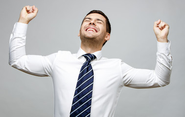 Handsome stylish businessman on grey background