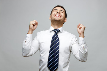 Handsome stylish businessman on grey background