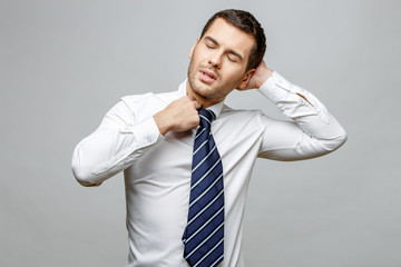 Handsome stylish businessman on grey background