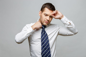 Handsome stylish businessman on grey background