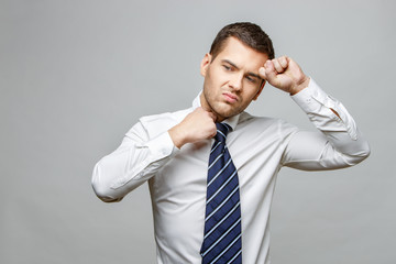 Handsome stylish businessman on grey background