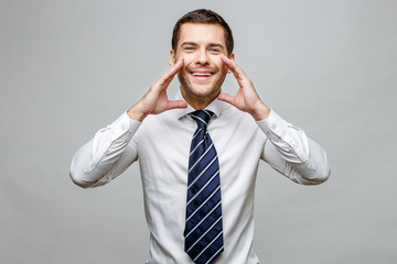 Handsome stylish businessman on grey background