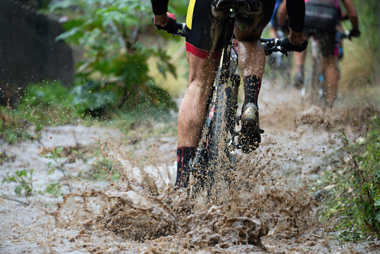 Mountain Bikers Driving In Rain Upstream Creek