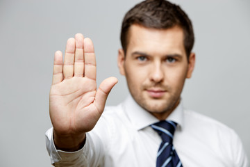 Handsome stylish businessman on grey background