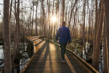 Man walking trail in early morning