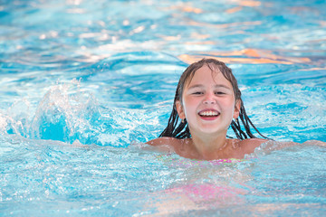 Little girl in swimming pool. Summer outdoor